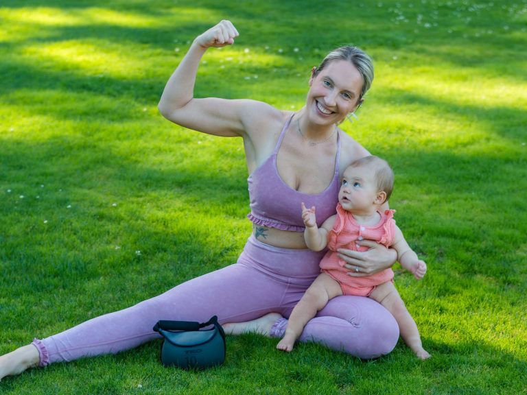 pexels-photo-9472308 woman in pink tank top carrying baby on her lap