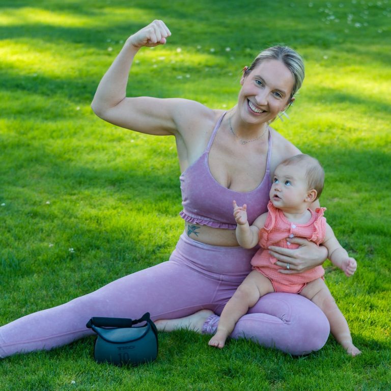 pexels-photo-9472308 woman in pink tank top carrying baby on her lap