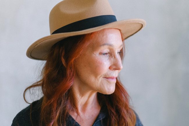 pexels-photo-5257501 senior woman with wrinkles and red hair in hat