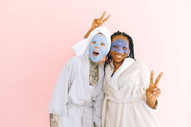 pexels-photo-3852150 happy multiethnic female friends in sheet masks showing peace gesture