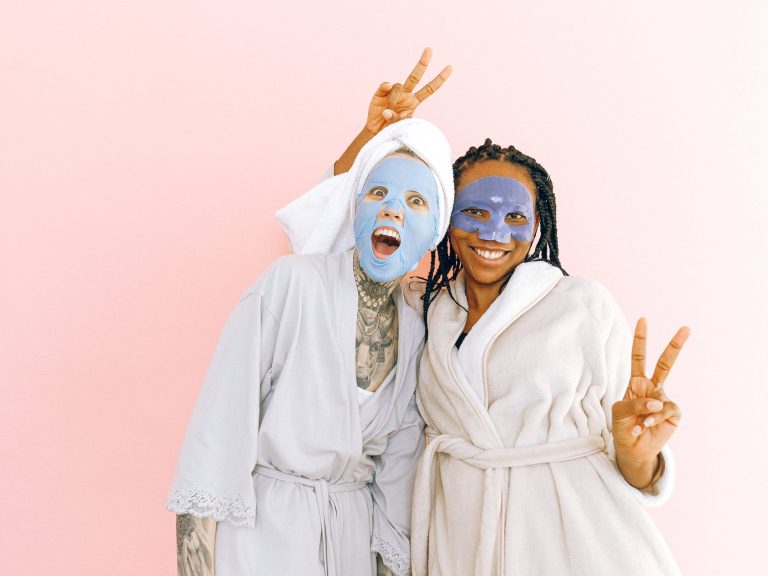 pexels-photo-3852150 happy multiethnic female friends in sheet masks showing peace gesture