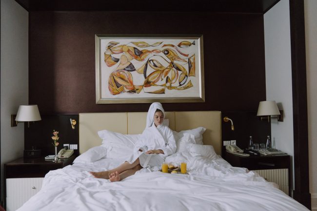 pexels-photo-5379219 woman in bathrobe sitting on bed