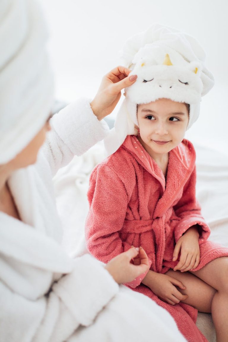 mother and daughter in dressing gowns and with their hair wrapped in a towel