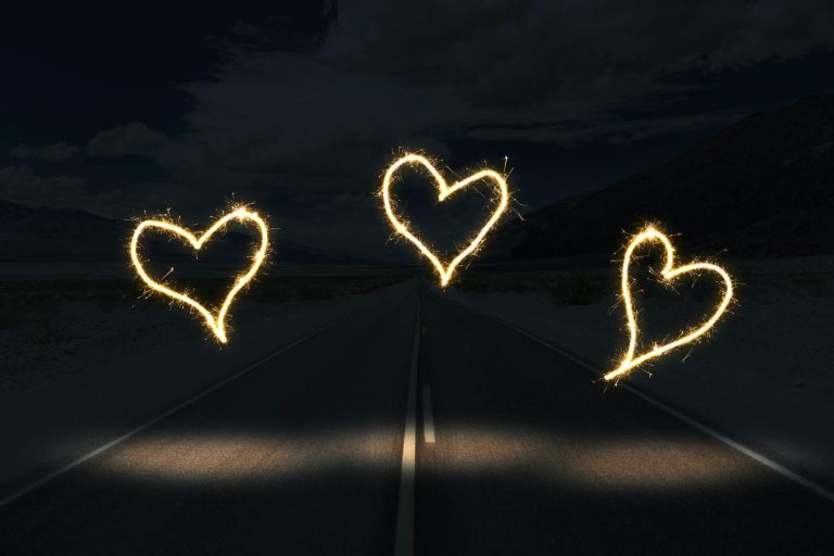 pexels-photo-3633016 white light forming heart on black surface