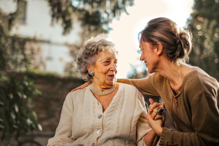 pexels-photo-3768131 joyful adult daughter greeting happy surprised senior mother in garden