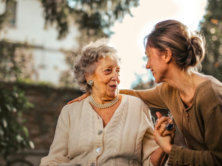 pexels-photo-3768131 joyful adult daughter greeting happy surprised senior mother in garden