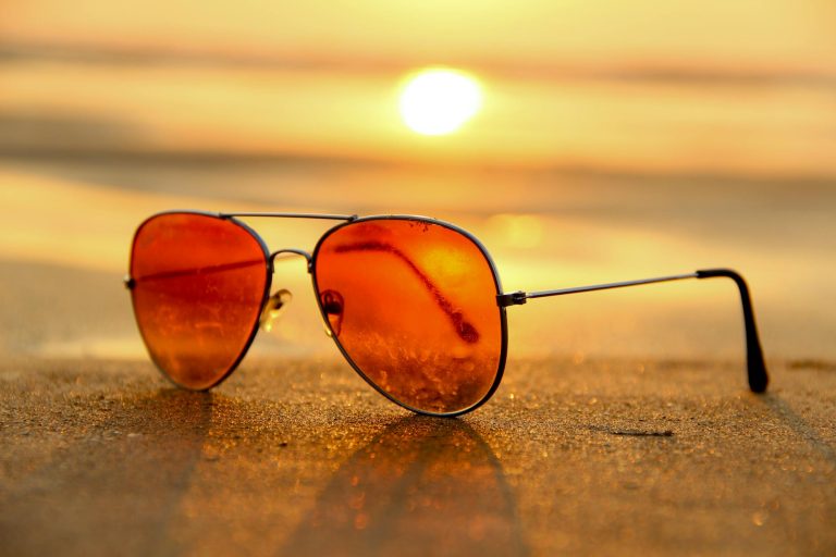 pexels-photo-46710 red lens sunglasses on sand near sea at sunset selective focus photography
