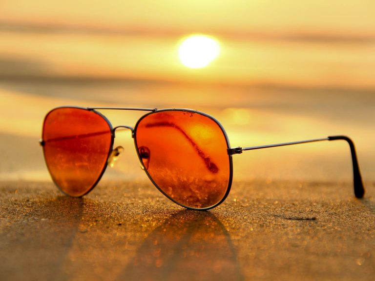 pexels-photo-46710 red lens sunglasses on sand near sea at sunset selective focus photography