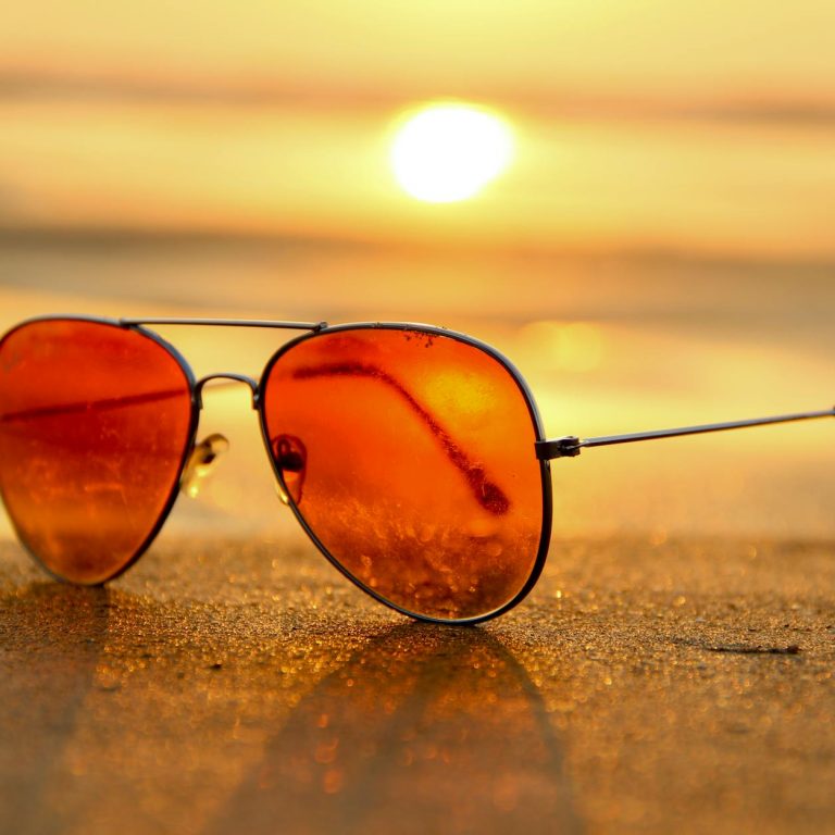 pexels-photo-46710 red lens sunglasses on sand near sea at sunset selective focus photography