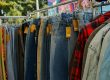 close up of clothes with price tags hanging on a clothing rack at a flea market