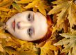 redhead model face among autumn leaves