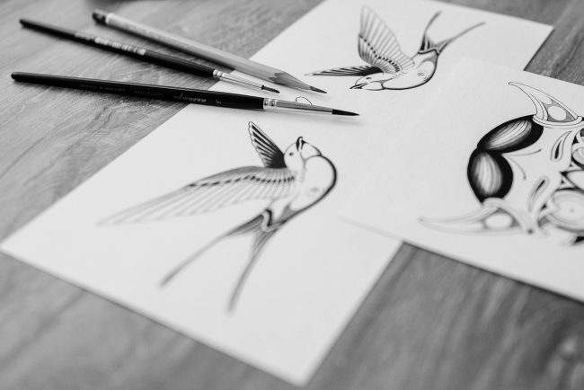 pexels-photo-6593531 black paintbrushes on top of white paper