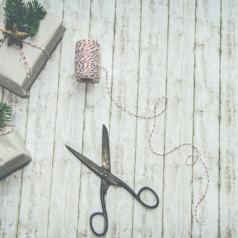 two gray and green christmas themed gift boxes